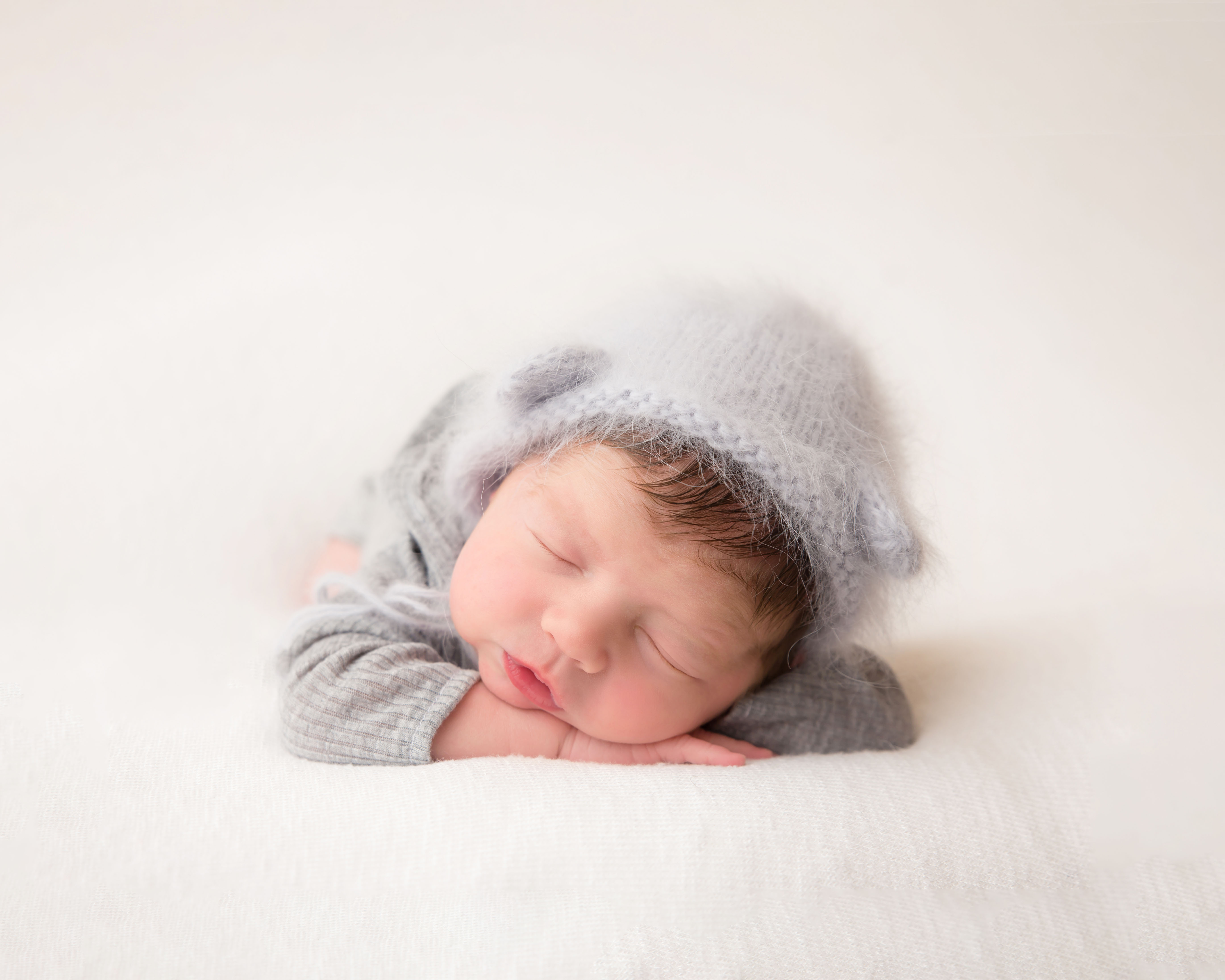 Baby in soft coloured background - Wirral Baby Studio