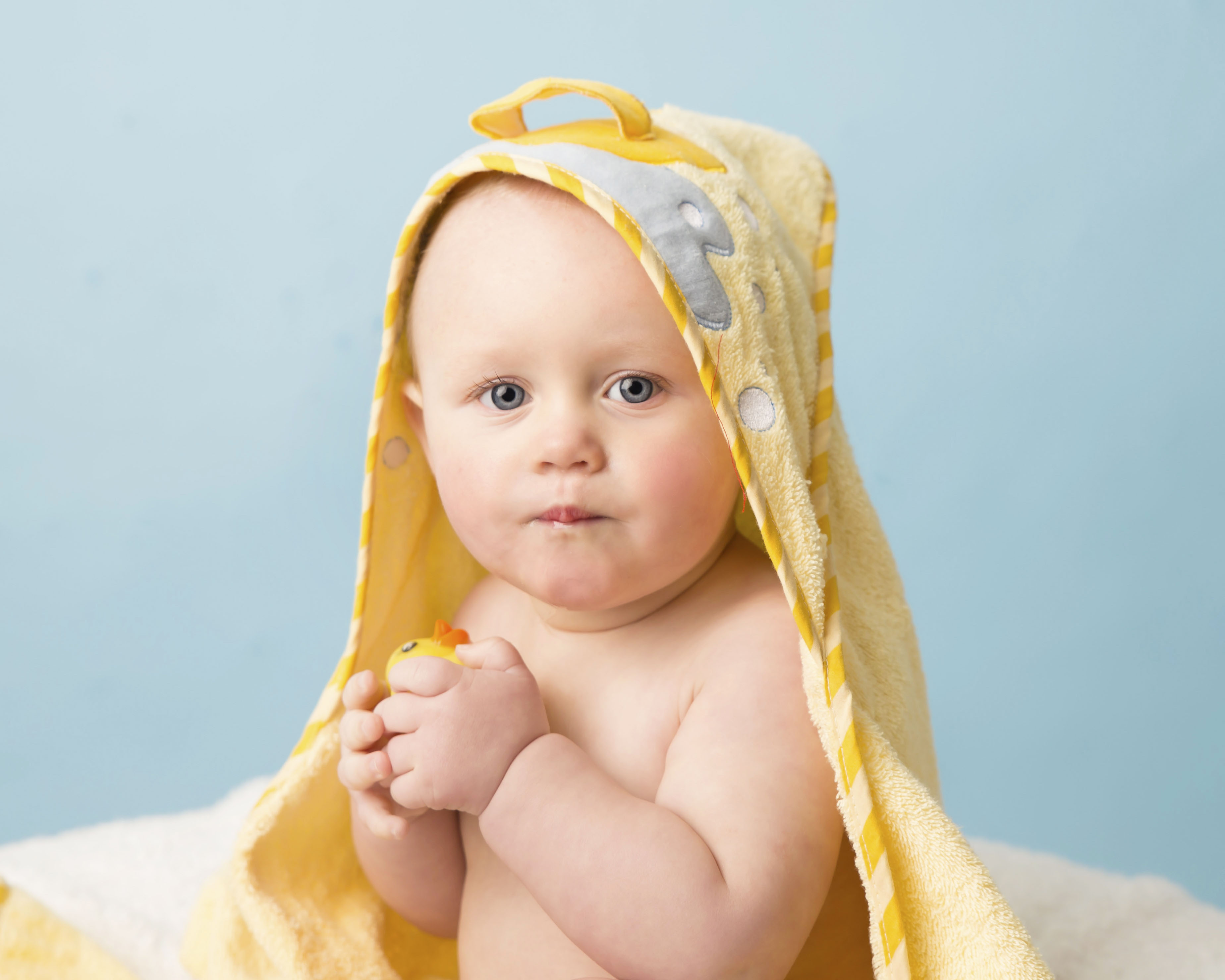 Boy drying off in a yellow towel after a Wirral based Cake Smash